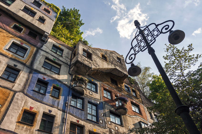bottom view on exterior of famous colorful hundertwasser house in vienna, austria.