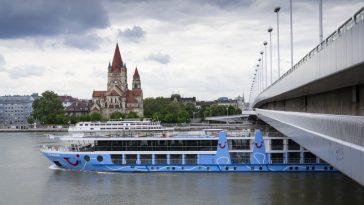 cruise ship on danube with st. francis of assisi church on mexikoplatz