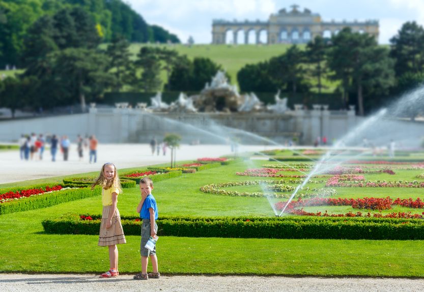 children in schönbrunn palace garden and gloriette on hill top