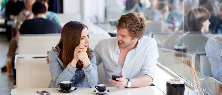 young couple talking in coffee shop