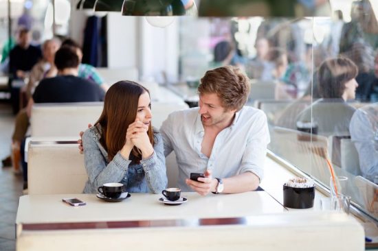 young couple talking in coffee shop