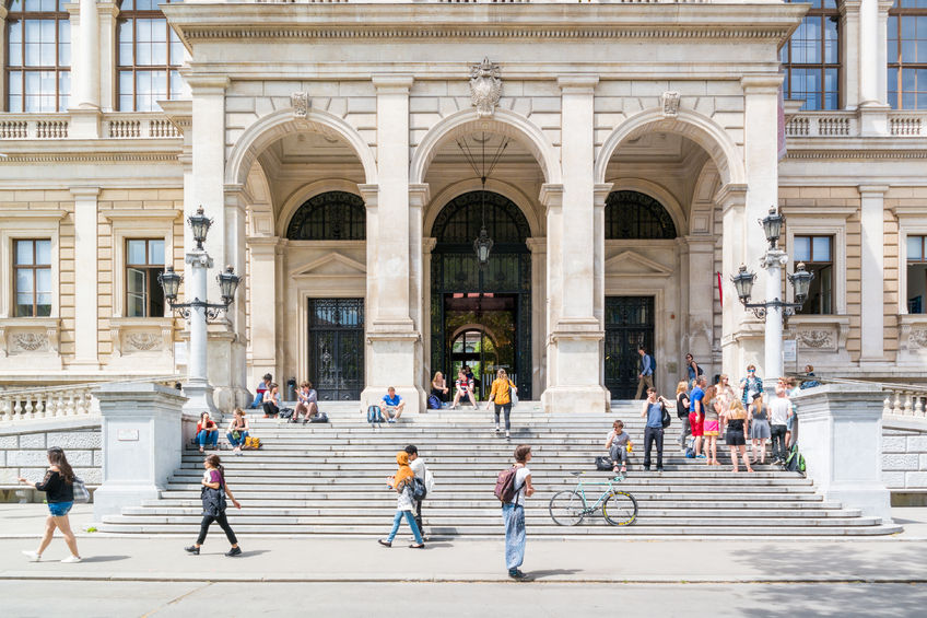 people at entrance of main building of university on ringstrasse in inner city of vienna