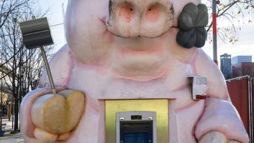 atm in a pink pig shape, in the city park