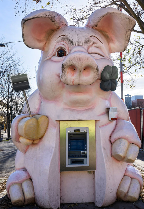 atm in a pink pig shape, in the city park