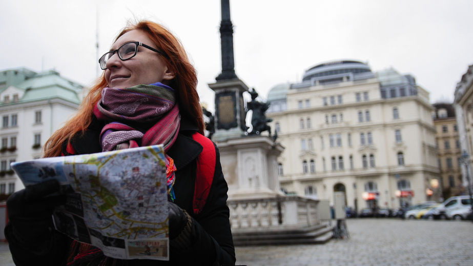 young red hair woman using city map