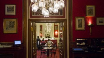 interior of the famous sacher hotel bar, with people around