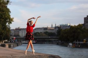 Beautiful ballerina dancing on the street in front of vienna